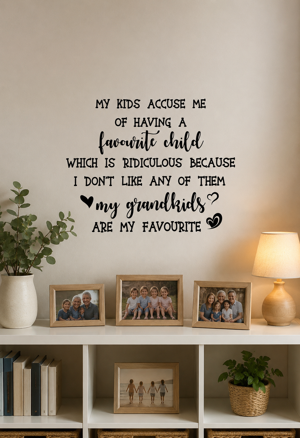 Favourite Child removable wall decal displayed above a bookshelf in a cosy family home with framed grandchildren photos and modern décor.