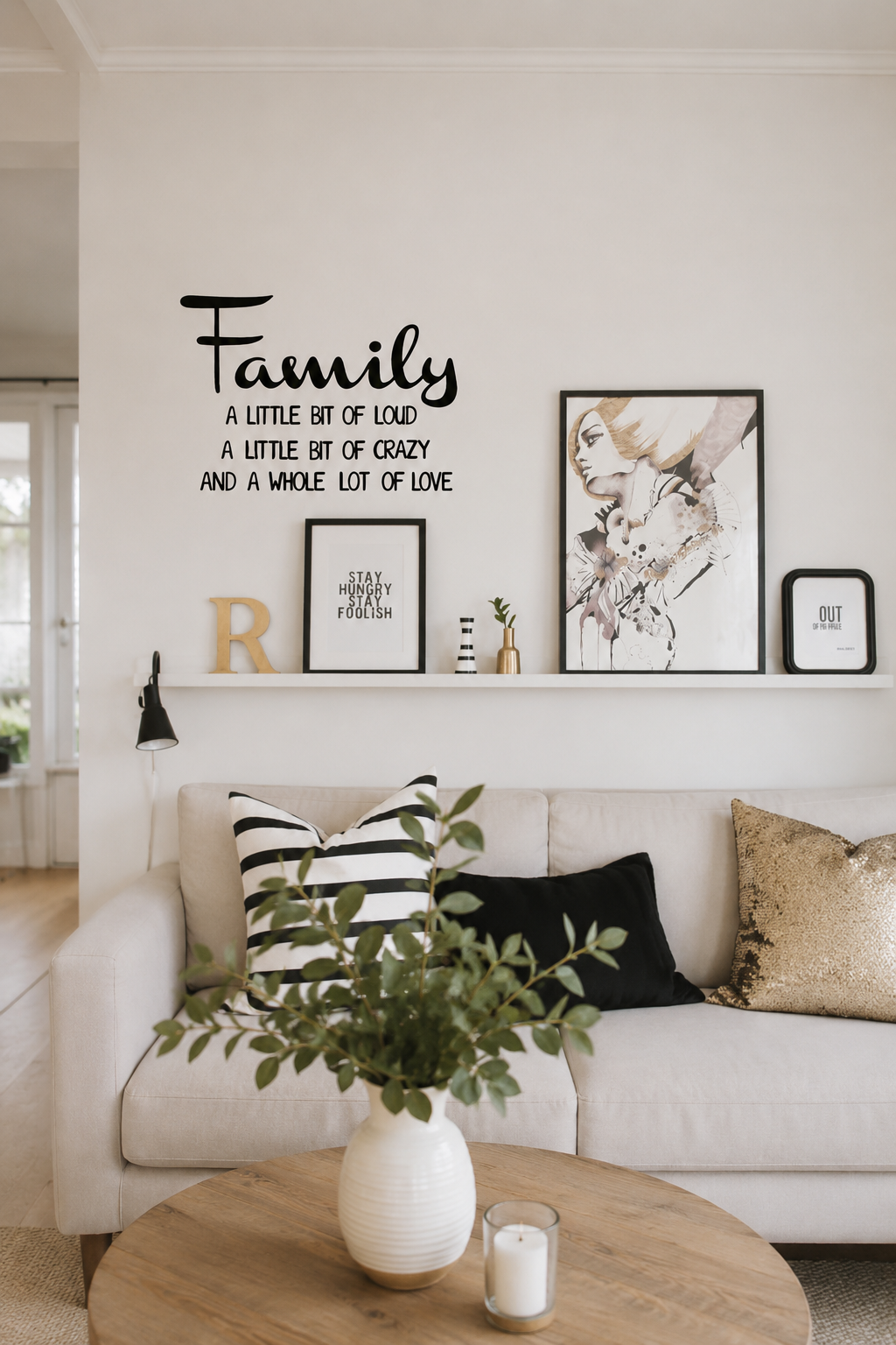 Family A Little Bit of Loud removable wall decal displayed on a living room feature wall above a sofa with modern home décor.
