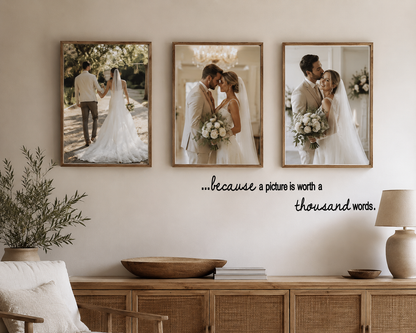 Because a Picture is Worth a Thousand Words removable wall decal above a family photo gallery wall in a warm neutral modern home with wooden frames.
