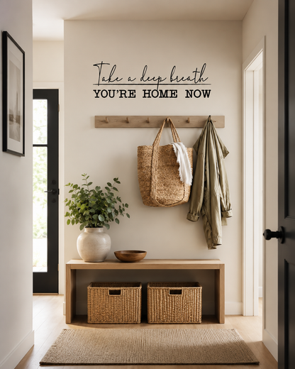 Take a Deep Breath You're Home Now removable black wall decal displayed in a modern home entrance hallway.