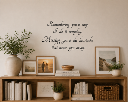 “Remembering You” removable wall decal displayed above a wooden bookshelf in a warm modern boho styled room with framed photos, greenery and neutral décor.