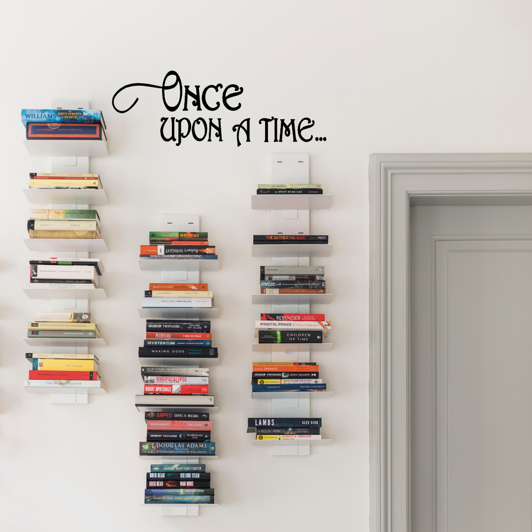 Children's bedroom with a bed, teddy bear, and decorative pillows, featuring a 'Once Upon a Time' wall decal. Two Little Giggles Wall Decal