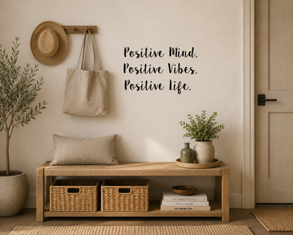 Positive Mind Positive Vibes Positive Life removable wall decal displayed above a timber entryway bench in a neutral modern home interior.
