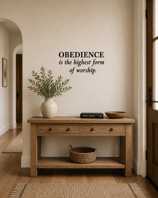 Obedience is the highest form of worship wall decal in black vinyl above wooden console table, faith-based hallway décor