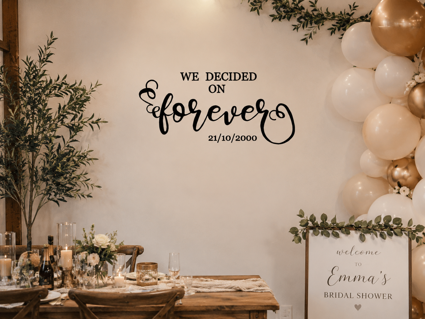 Wedding-themed decor with balloons, flowers, and a sign on a wall.