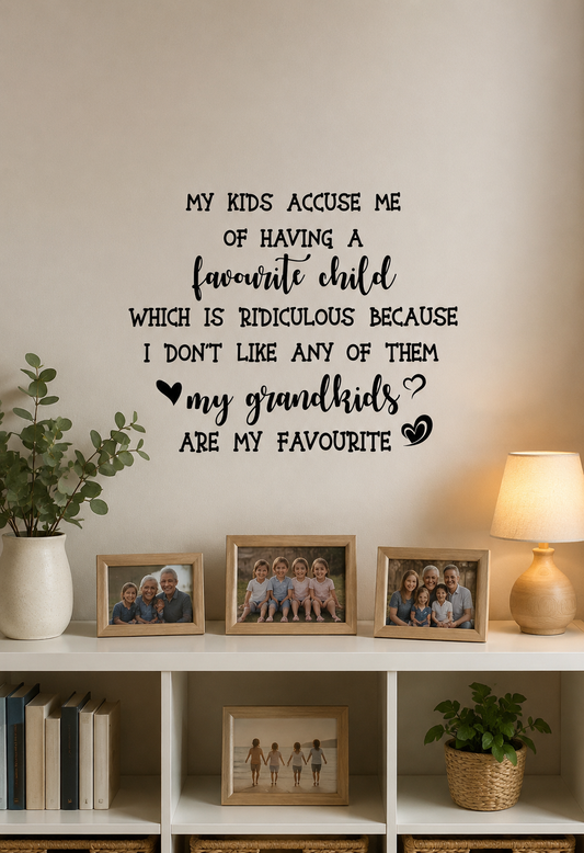 Favourite Child removable wall decal displayed above a bookshelf in a cosy family home with framed grandchildren photos and modern décor.
