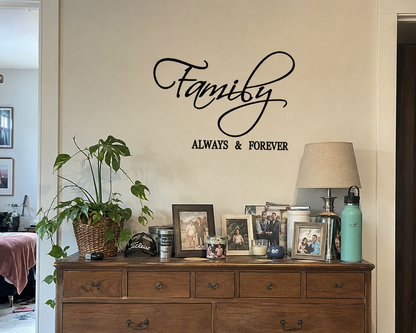 “Family Always & Forever wall decal displayed above a rustic wooden dresser in a cozy lived-in home with framed family photos, indoor plants, and warm neutral décor.”