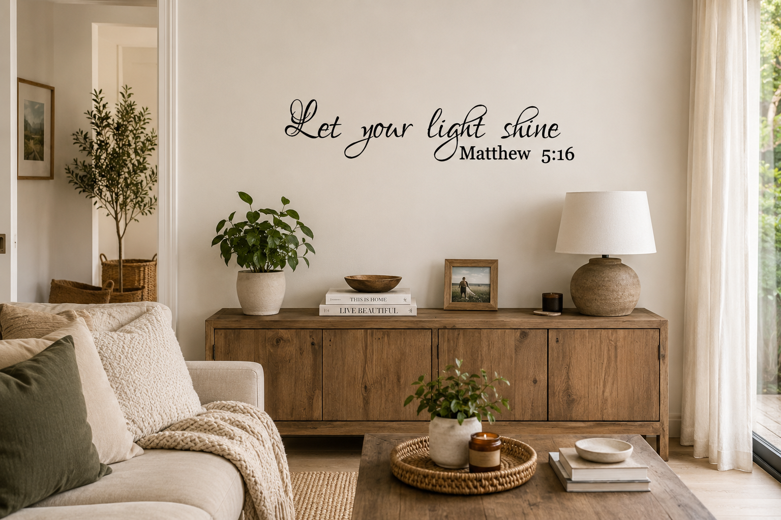 Let Your Light Shine Matthew 5:16 removable black vinyl wall decal displayed in a warm neutral living room with wooden furniture and relaxed modern décor.