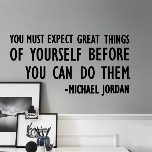 Wall decal with a motivational quote by Michael Jordan on a gray wall. Two Little Giggles Wall Decals