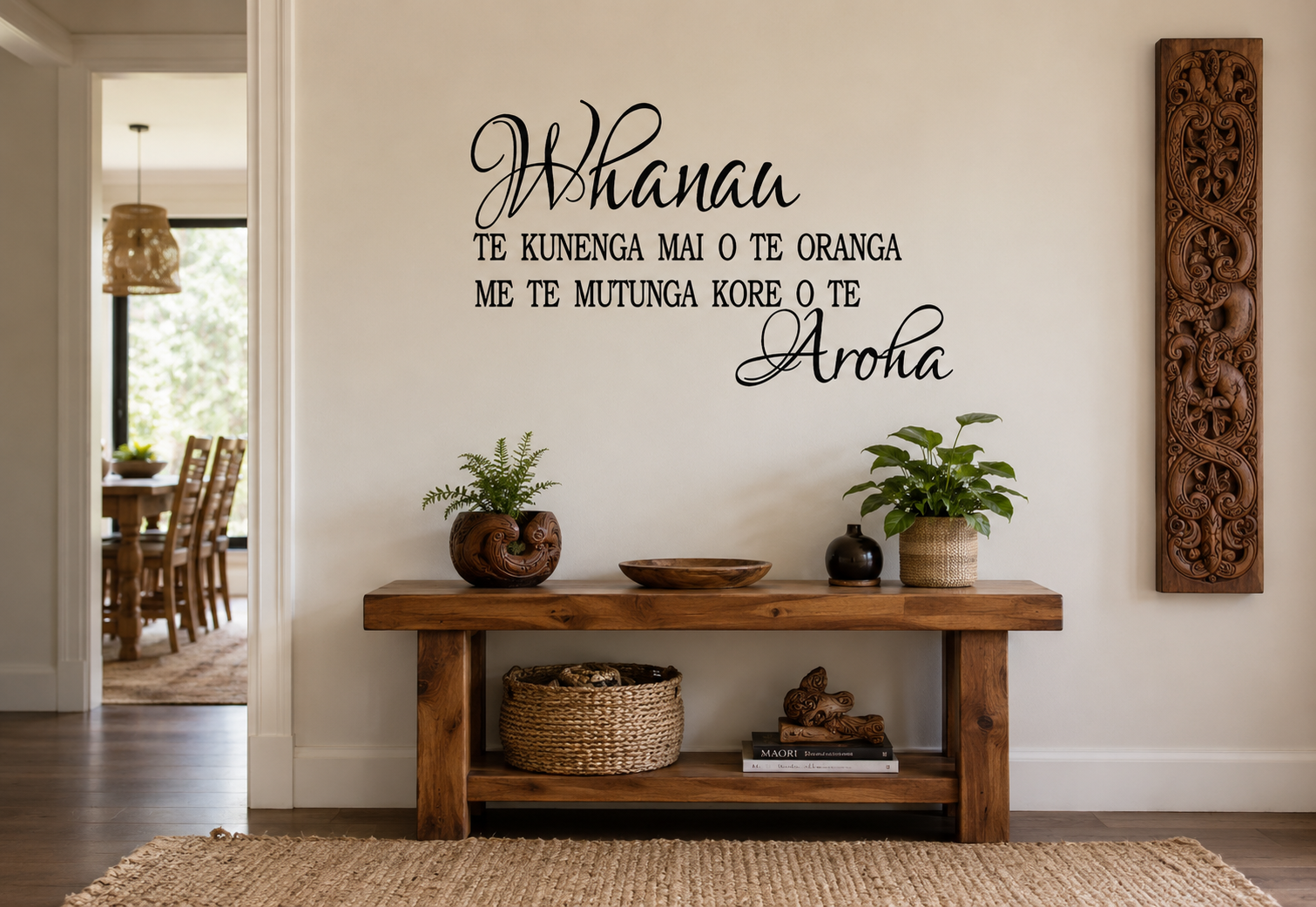 Whānau Māori-inspired removable vinyl wall decal displayed in a warm modern hallway with natural wooden furniture and Māori carving décor.