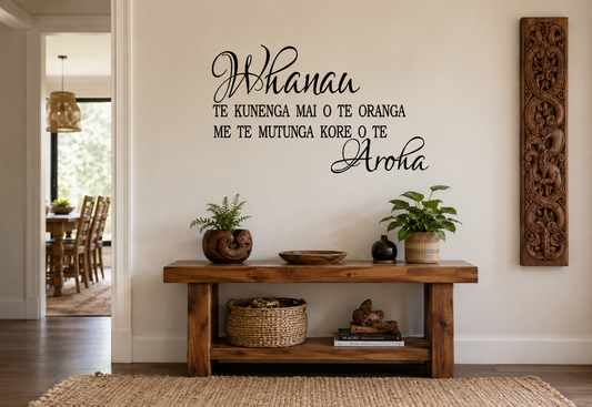 Whānau Māori-inspired removable vinyl wall decal displayed in a warm modern hallway with natural wooden furniture and Māori carving décor.