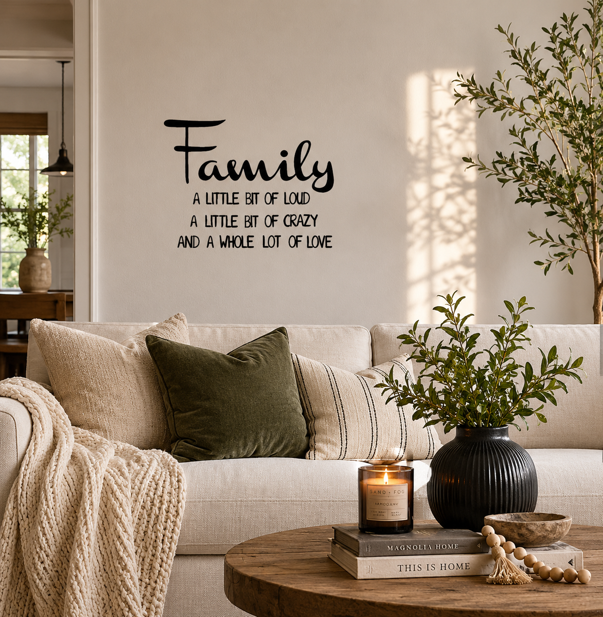 Family A Little Bit of Loud removable wall decal displayed on a living room feature wall above a sofa with modern home décor.