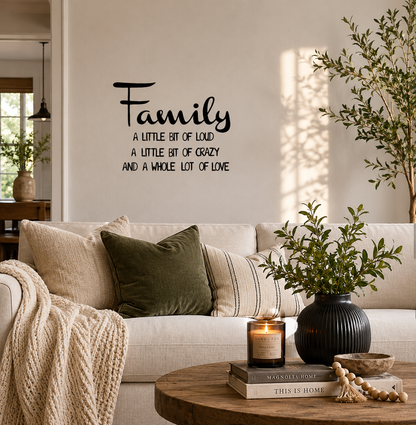 Family A Little Bit of Loud removable wall decal displayed on a living room feature wall above a sofa with modern home décor.