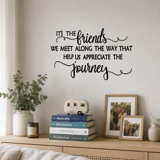 Black friendship quote wall decal above a wooden shelf with books, framed photos, and home decor in a Scandinavian-style living room.